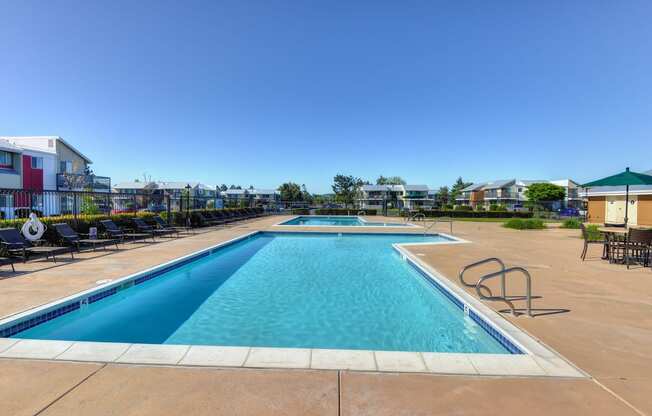 Swimming Pool Outside Community Space with Lounge Chairs, Gate, Apartment Exteriors