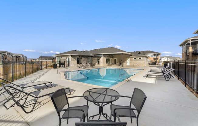 our apartments have a swimming pool with chairs and tables
