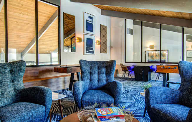 a living room with blue chairs and a table  at Veranda La Mesa, La Mesa, 91942