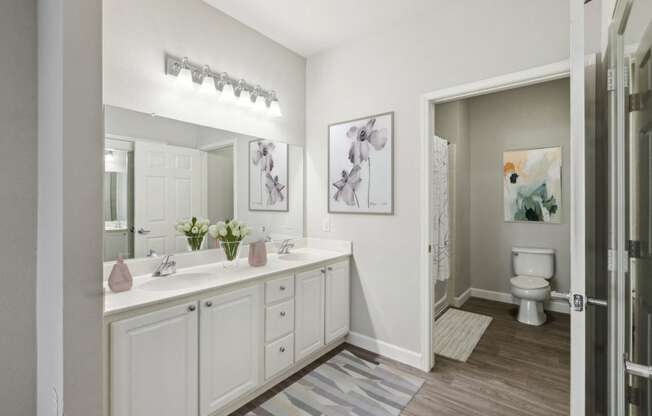 a white bathroom with a sink and a mirror