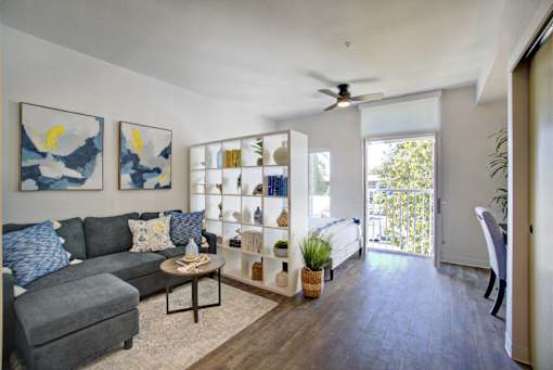 A living room with a grey couch and a coffee table.