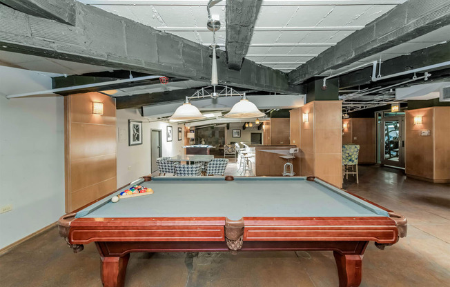a pool table in the middle of a room in a loft