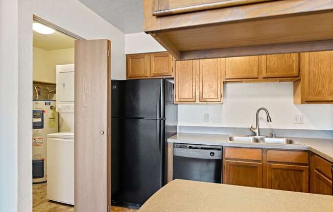 a kitchen with black appliances and wooden cabinets