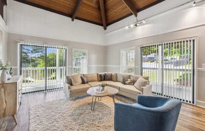 a living room with a couch and chairs and a rug