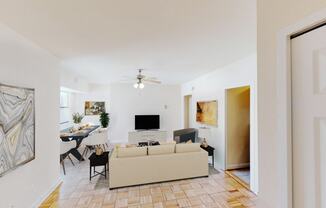 living area with sofa, dining area, tv, credenza, ceiling fan and hardwood flooring  at hilltop house apartments in columbia heights washington dc