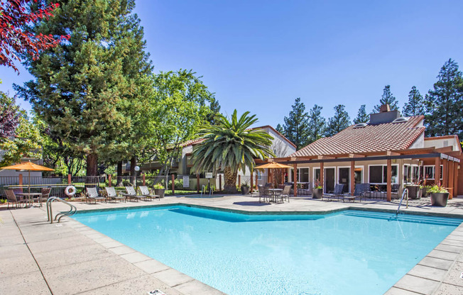 a swimming pool in front of a house with a pool at Valley Plaza Villages, Pleasanton, 94566