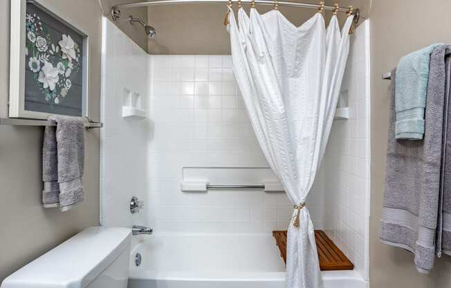 a bathroom with a shower curtain and a tub and a sink