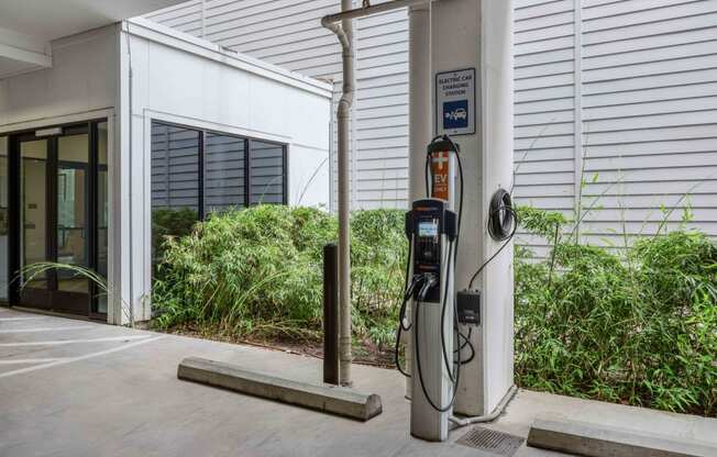 a gas station in front of a white building