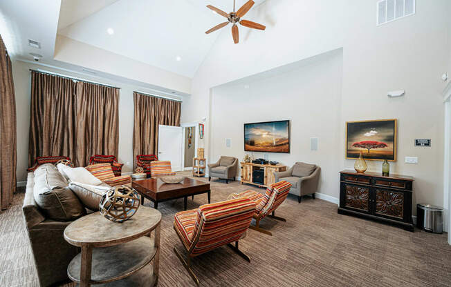 a living room with furniture and a ceiling fan
