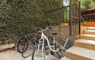 a group of bikes parked next to some stairs