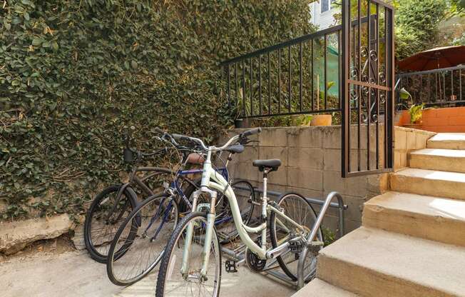 a group of bikes parked next to some stairs