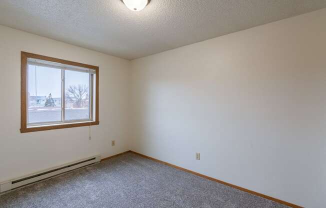 a bedroom with a window. Fargo, ND Crescent Park Apartments