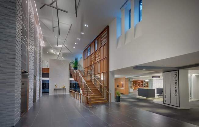 A modern interior space with a staircase and a glass wall.