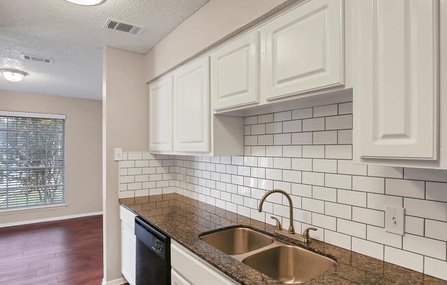 a kitchen with a sink and a window