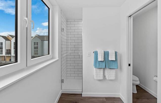 A bathroom with a towel rack holding two towels.