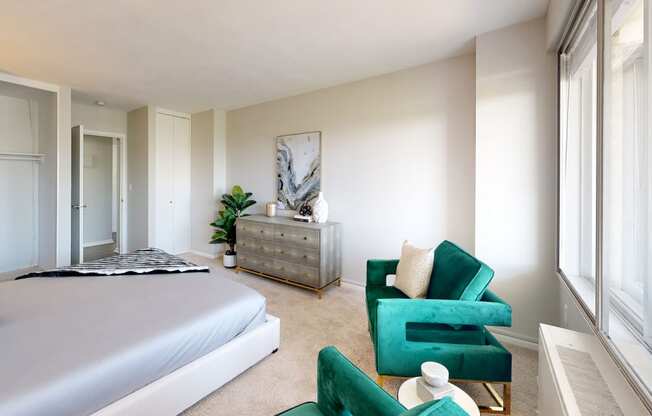 a bedroom with a bed and a dresser in front of a window