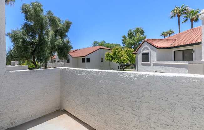 a view from the balcony of a house with a wall and a house at Tides at Mesa, Mesa, 85204