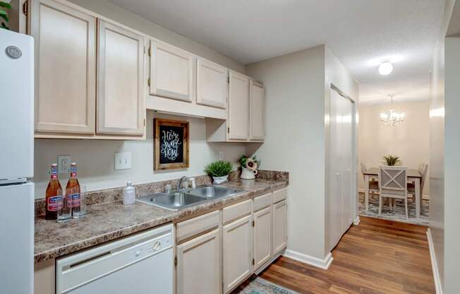 A kitchen with wooden cabinets and a white fridge.