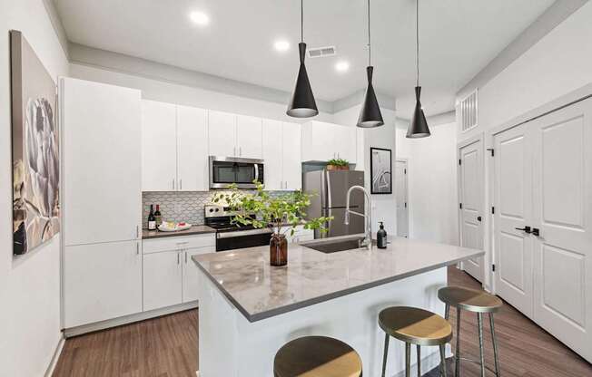 A kitchen with a white counter and bar stools.