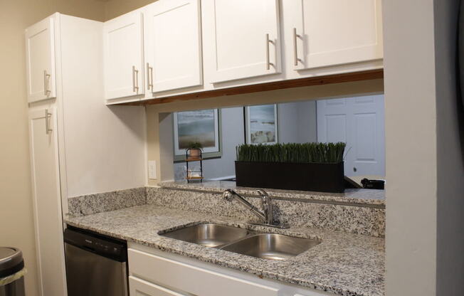 Stillwater apartment kitchen with white cabinets and granite countertops