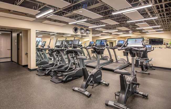 A gym with treadmills and elliptical machines.