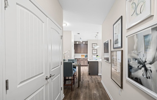 a view of a kitchen and living room from a hallway