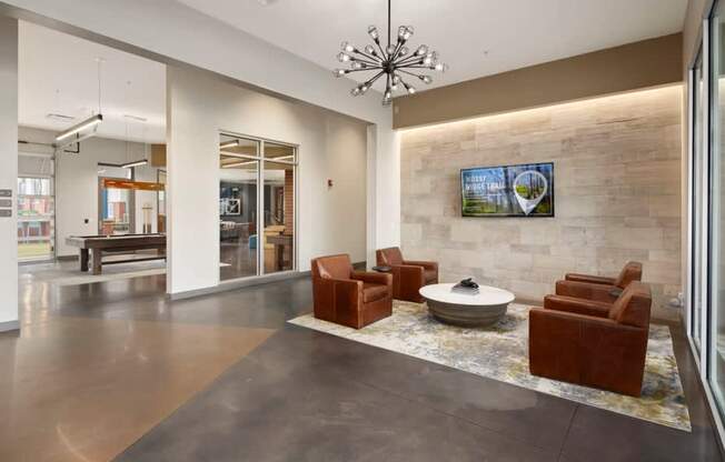 A modern living room with a stone wall and a flat screen TV.