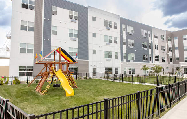 a playground in the middle of an apartment building with a slide at Technology Park Apartments, Minnesota
