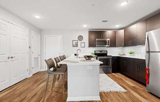 A kitchen with a white island and brown cabinets.