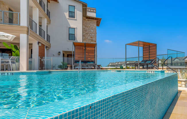 a swimming pool with a building in the background