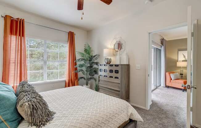 a bedroom with a large bed and a ceiling fan
