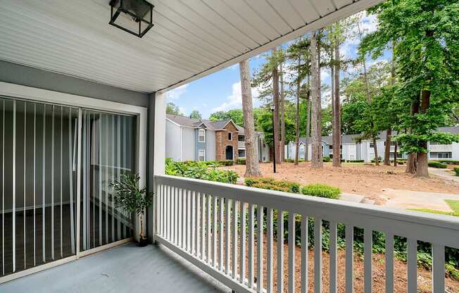 A balcony with a white railing and a view of a residential area. at Mill House at East Cobb, Georgia ,30067