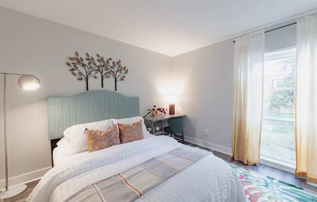 a bedroom with a bed and a rainbow painted wall