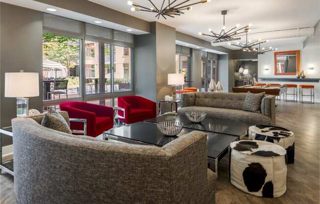 a lobby of a hotel with couches and tables and chairs
