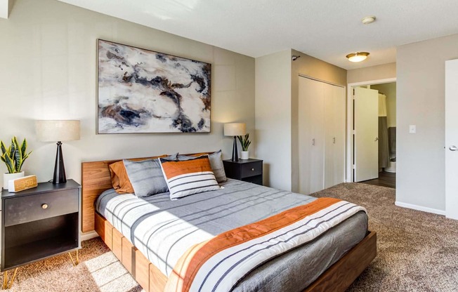 a bedroom with a bed and two night stands