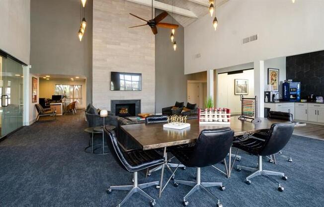 a large room with a table and chairs and a fireplace