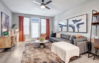 a living room with a couch and a ceiling fan
