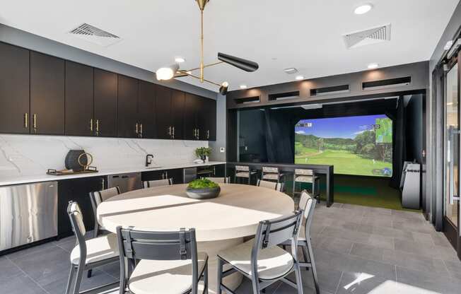 a dining room with a table and chairs and a large screen tv