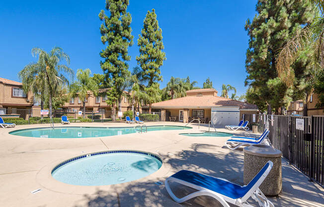 our apartments have a swimming pool with chairs and trees