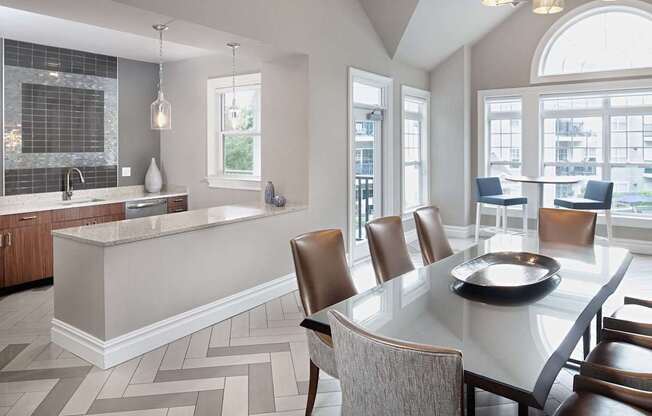 a kitchen and dining room with a table and chairs
