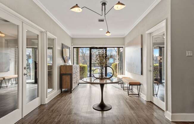 a dining room with a table and chairs in front of a window