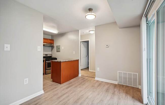 a renovated living room and kitchen with wood flooring and an open floor plan at ReNew Odenton