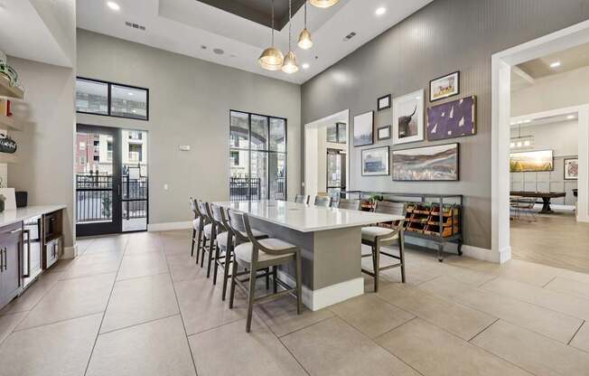 A kitchen with a bar area and a dining table.