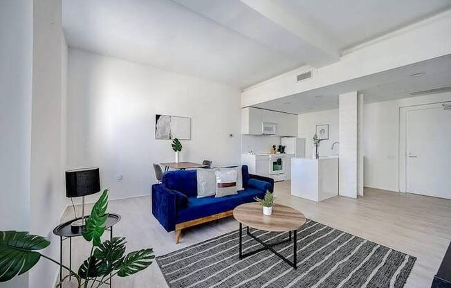 a living room with a blue couch and a table