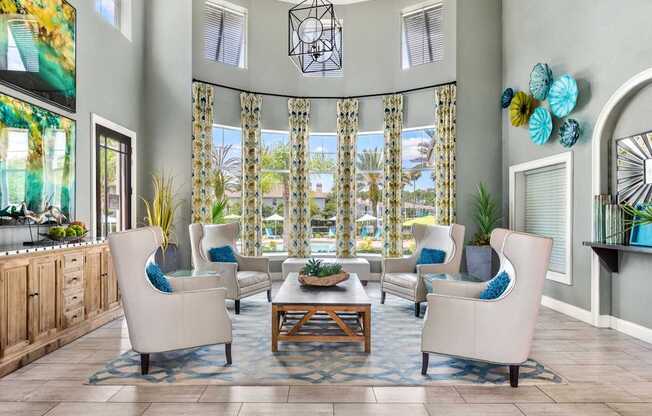 A living room with a large window and a view of a pool.