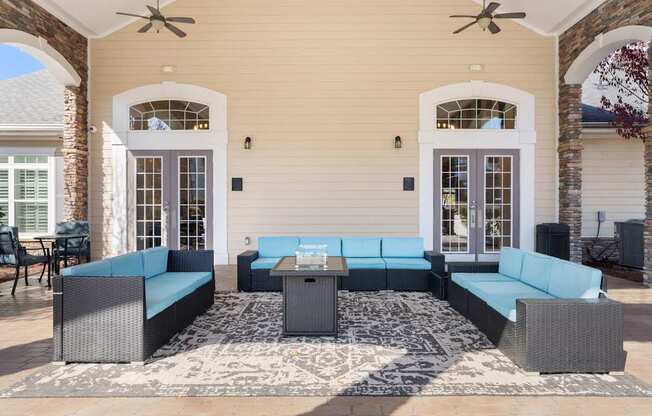 A patio with a table and chairs is set up outside a house.