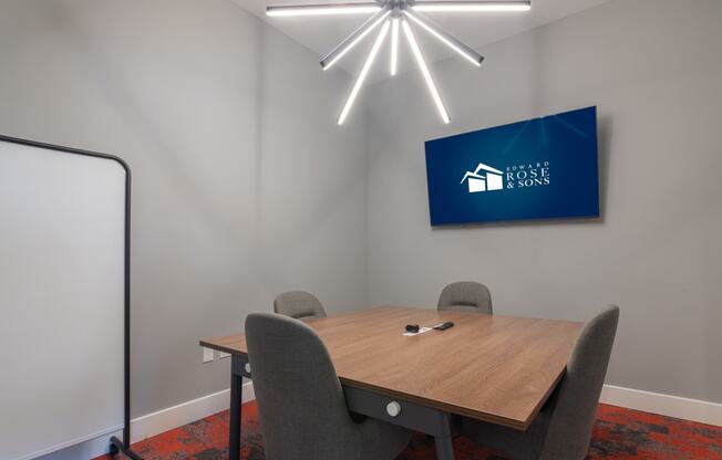 a conference room with a table and chairs and a sign on the wall