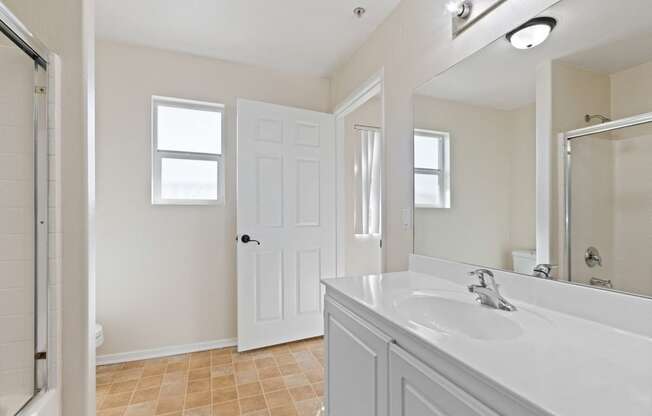 a bathroom with a sink and a mirror and a shower at Dronfield Astoria, California, 91342