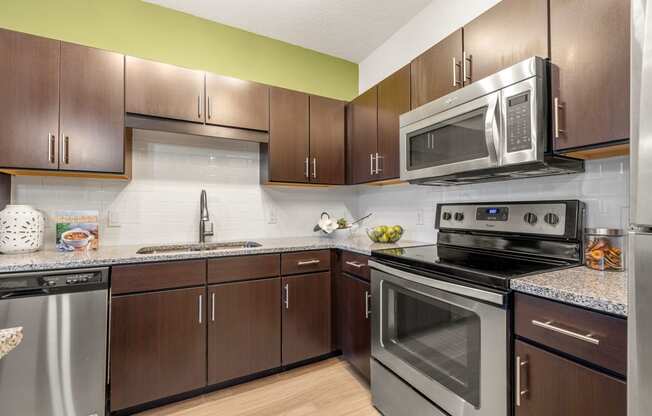 a kitchen with stainless steel appliances and wooden cabinets
