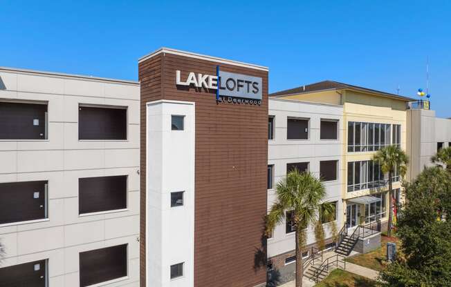 a view of the front of a building with a sign for lake acres apartments